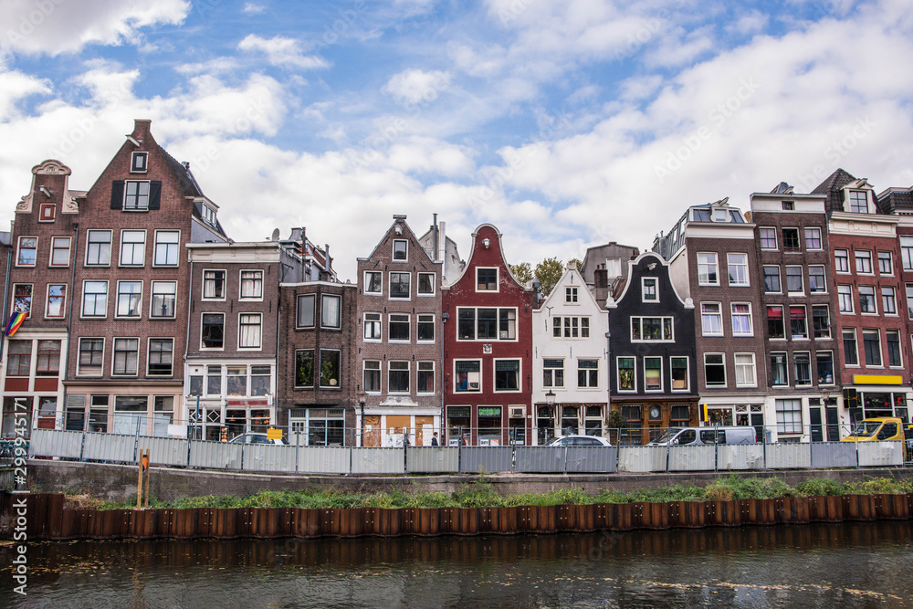 Amsterdam canal with typical dutch houses. Netherlands autumn cityscape.