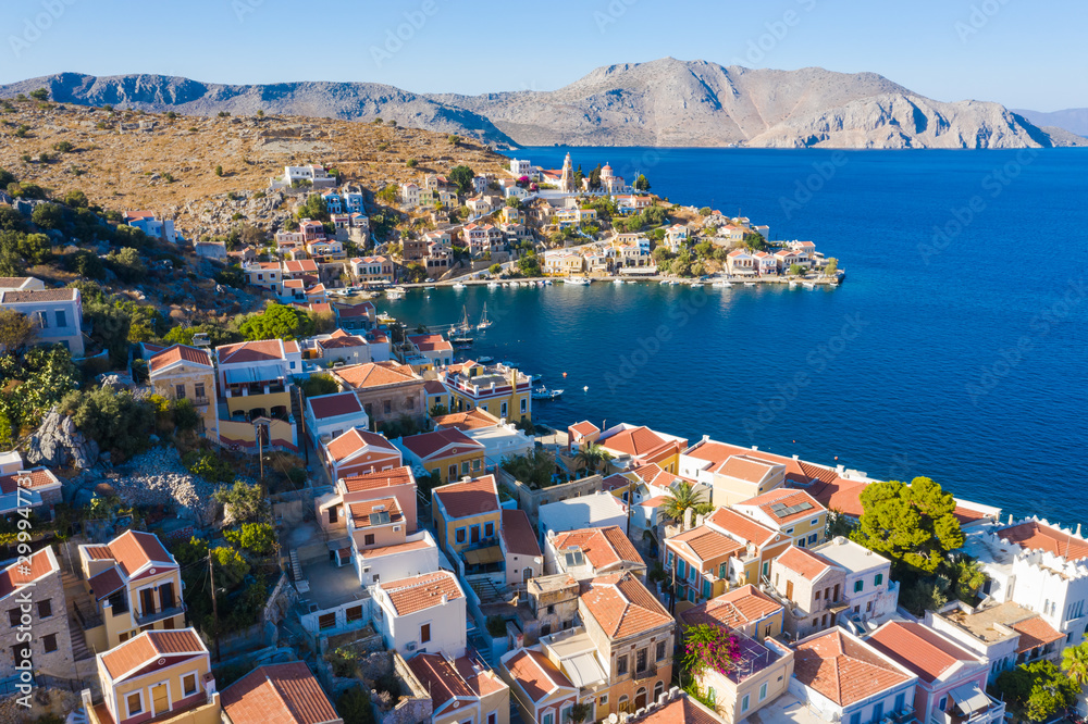 Symi, Dodecanese island, Greece. Beautiful bay with colorful houses on the hillside of famous popular tourist spot island of Symi