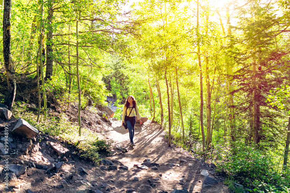 Maroon Bells Crater Lake hike with woman climbing steep dirt road in Aspen, Colorado in July 2019 summer Maroon Bells Crater Lake hike with woman climbing steep dirt road in Aspen, Colorado in July 2019 summer
