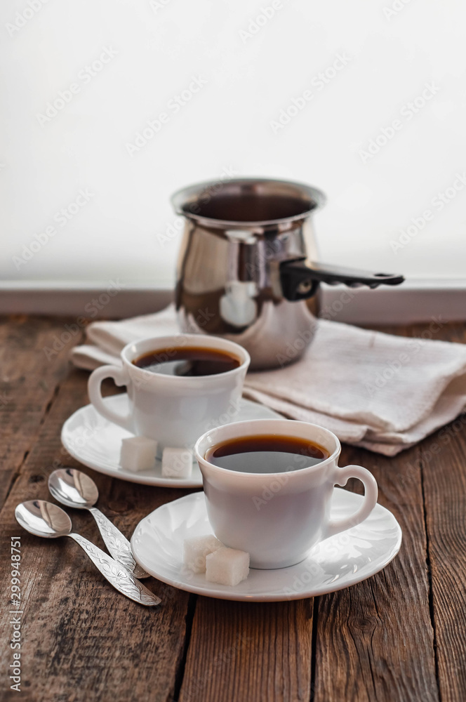 Fototapeta premium Coffee on a wooden table in white mugs