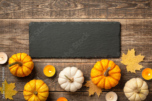 Thanksgiving background with pumpkins, autumn leaves and candles