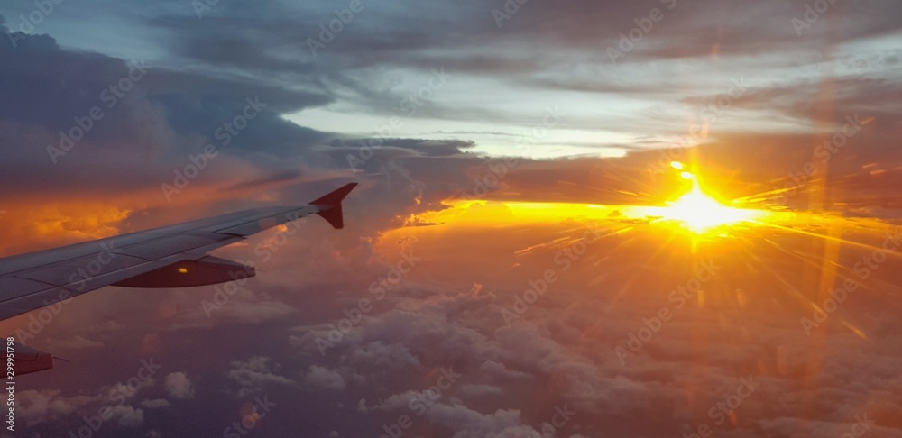 Aircraft or airplane wing on dark sky with sunset light background - Transportation, Travel and Beauty of Nature concept 