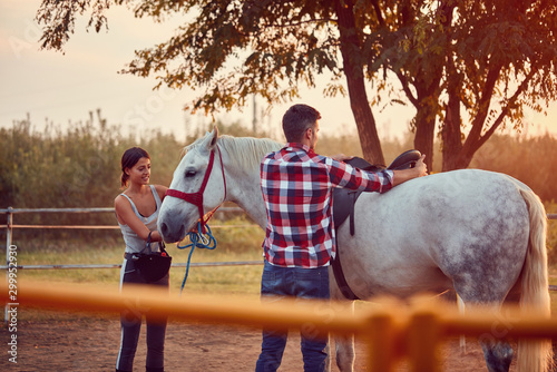 Couple on the farm with beautiful horse