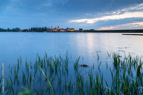 View of the medieval city of Mantua in the evening with Castello di San Giorgio, Palazzo Ducale and the dome of the Basilica of Sant'Andrea. Mantua, Lombardy, northern Italy, southern europe.