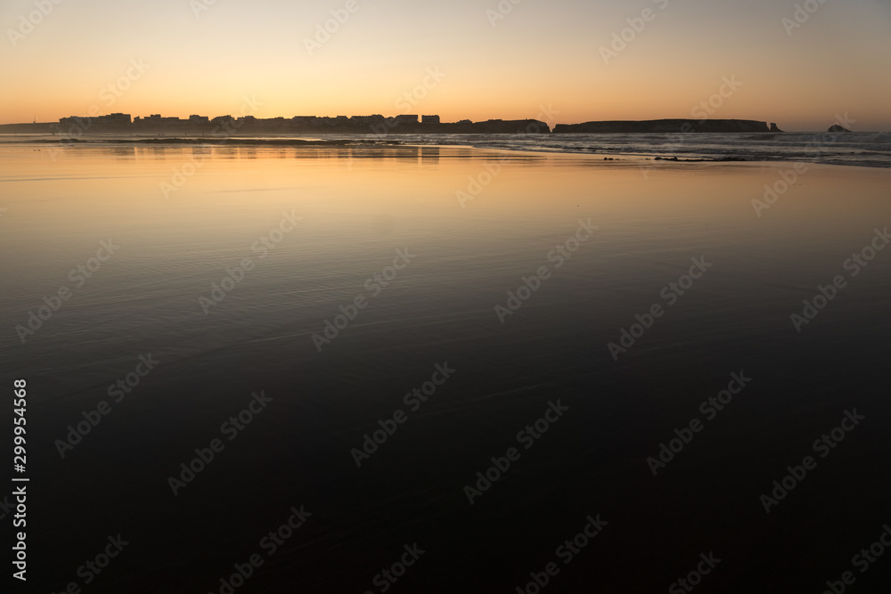 Sunset at Baleal beach with the baleal island in the background in Peniche, Atlantic coast of Portugal.