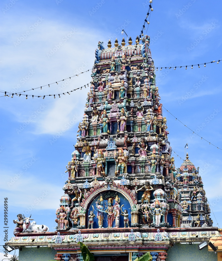 Beautiful roof of a Hindu temple in front of a blue sky