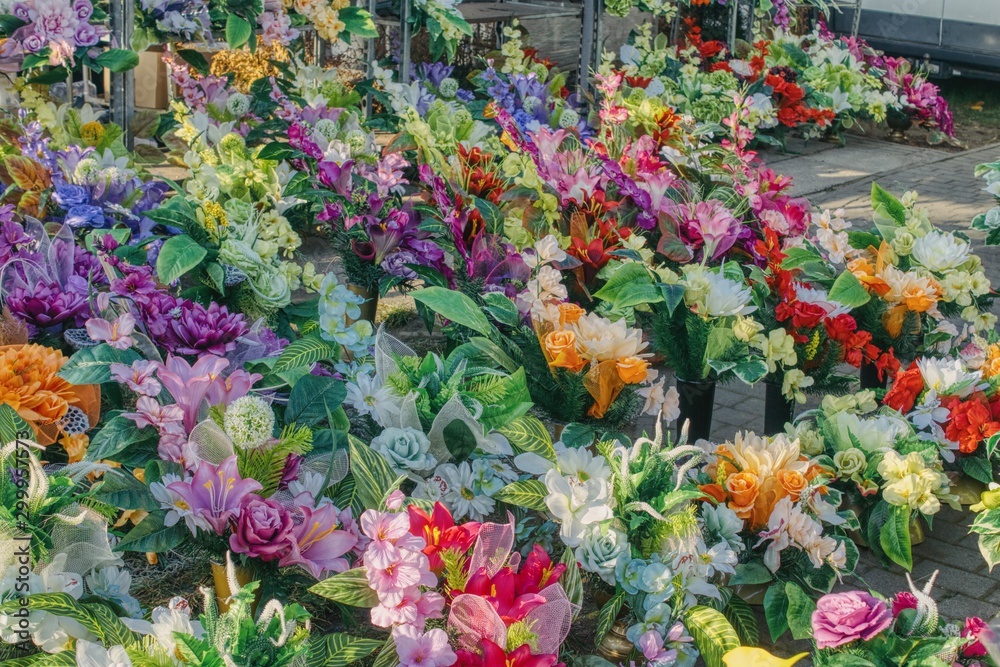 bouquets of artificial colored bouquets to decorate the graves on the day of the dead