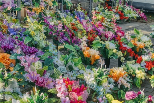 bouquets of artificial colored bouquets to decorate the graves on the day of the dead