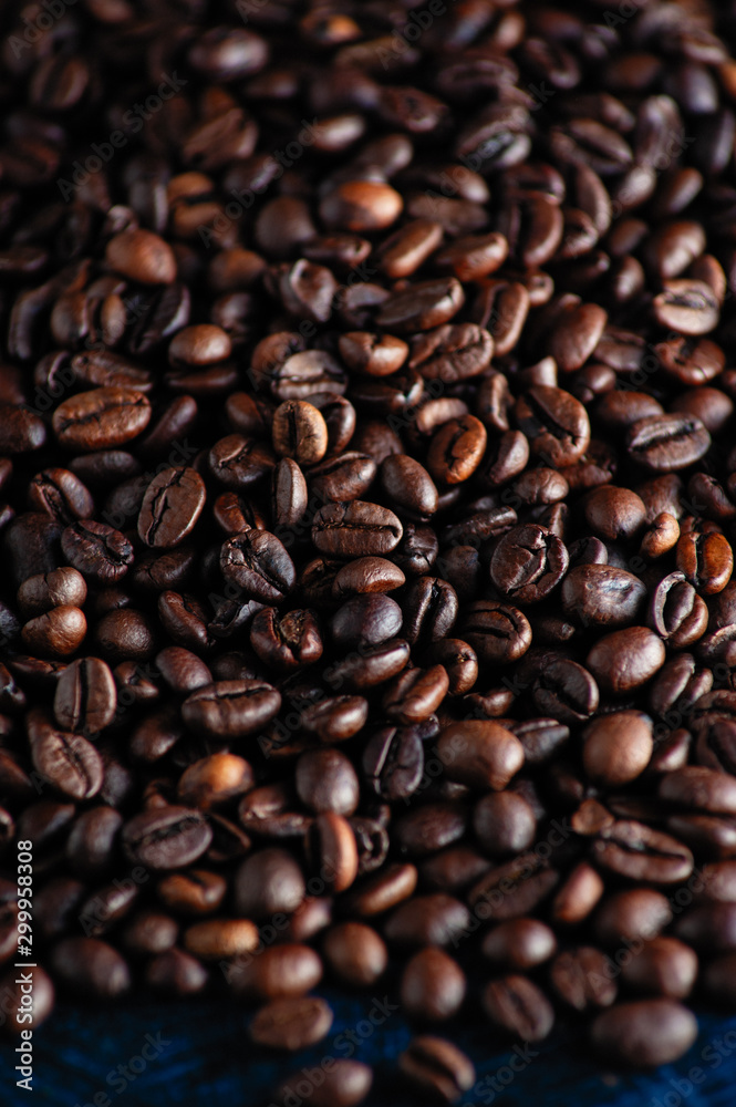 roasted aromatic coffee beans closeup sprinkled on a table roasted aromatic coffee beans closeup sprinkled on a table