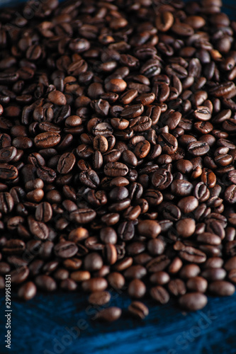 roasted aromatic coffee beans closeup sprinkled on a table © mira_y
