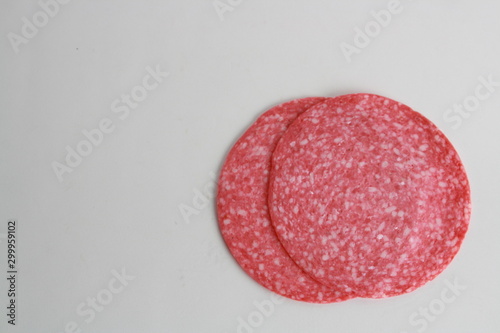 slices of salami on white background