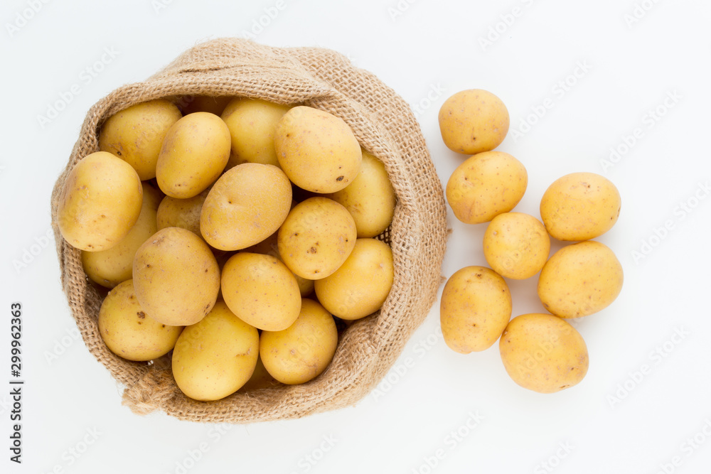 Sack of fresh raw potatoes on wooden background, top view Sack of fresh raw potatoes on wooden background, top view