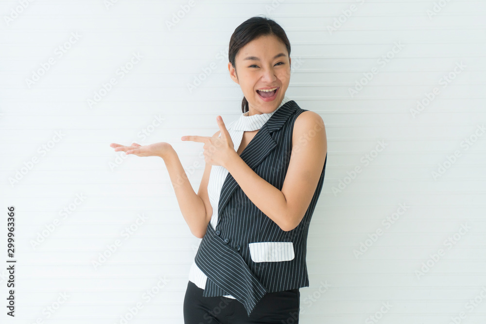 Asian beautiful young woman smile presenting with one hand on upper right side empty and left hand pointing. looking at camera in studio Isolated on white background. Advertisement& presentation conce Asian beautiful young woman smile presenting with one hand on upper right side empty and left hand pointing. looking at camera in studio Isolated on white background. Advertisement& presentation conce