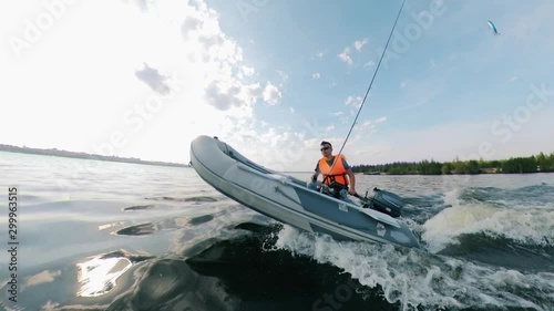 Zoom-in of an autoboat being navigated by a man photo