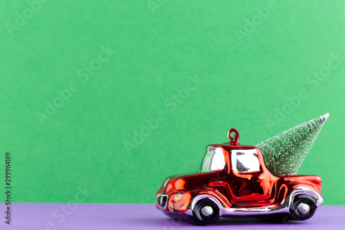 Christmas car on pastel color background. Christmas or New Year minimal concept. © gitusik