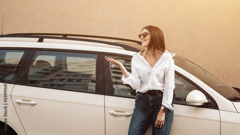 Close Up Portrait of One Stylish Young Female Dressed in Jeans and White Shirt Posing Near the Car, Business Lady, Woman Power Concept
