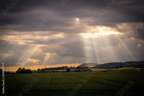 Beams of sunlight coming through evening clouds in Scotland