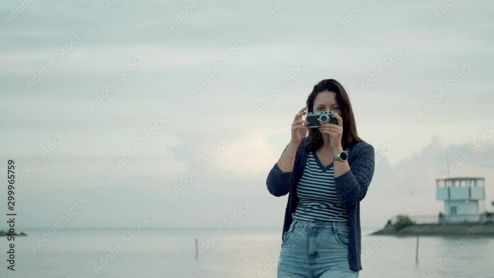 young woman takes photos on a retro camera outdoors. young woman takes photos on a retro camera outdoors.