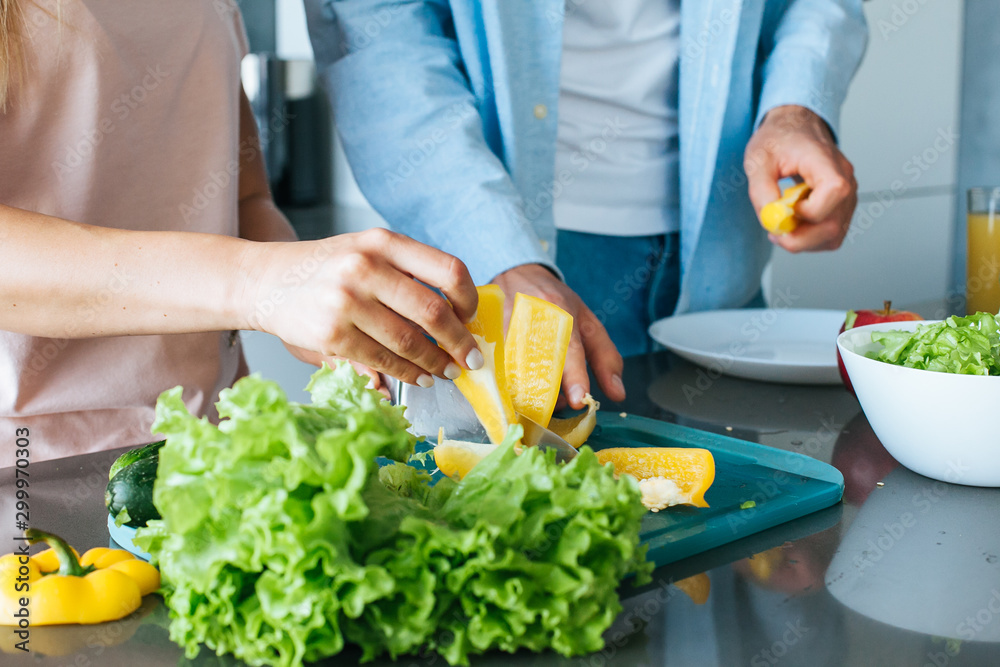 Young couple cooking a vegetarian breakfast in the morning in a bright kitchen Young couple cooking a vegetarian breakfast in the morning in a bright kitchen