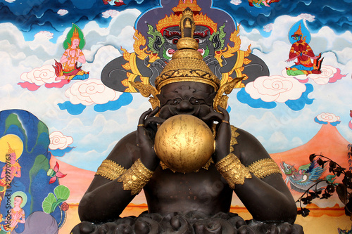 Black rahu statue with golden moon photo