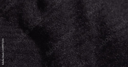 Black mohair fabric rotating close up. Warm winter clothing. photo