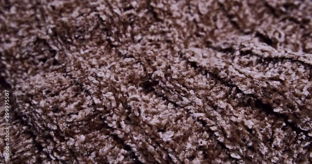 Woolen brown fabric, warm and cosy winter clothes. Close up, rotating shot. Woolen brown fabric, warm and cosy winter clothes. Close up, rotating shot.