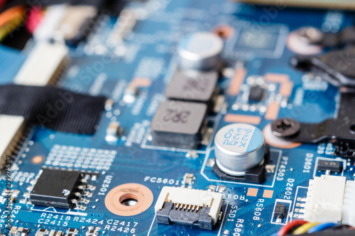 Electronic components, chips and capacitors on the blue pcb, close up view. Technology concept
