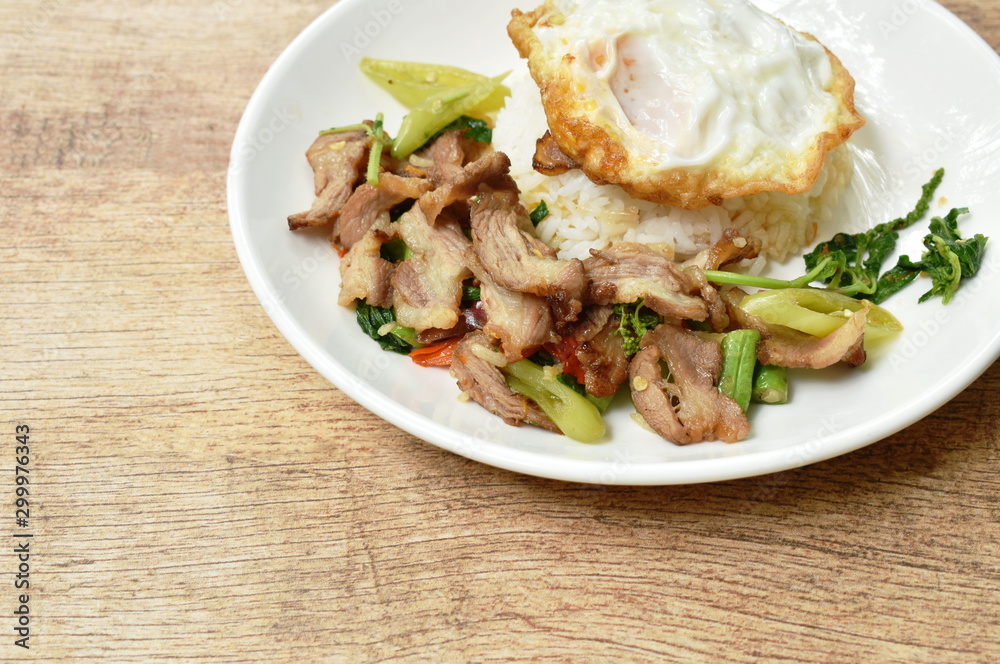spicy stir fried slice grilled pork with chili and basil leaf topping egg on dish spicy stir fried slice grilled pork with chili and basil leaf topping egg on dish