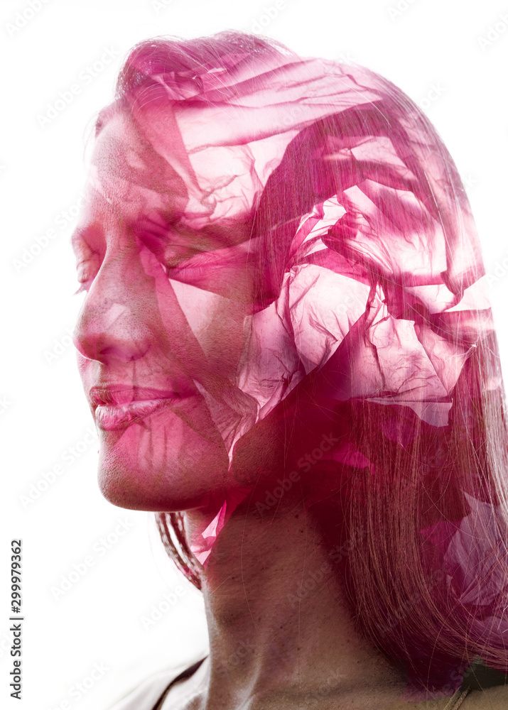 Double exposure profile portrait of a beautiful young woman combined with the unusual texture of a pink plastic bag