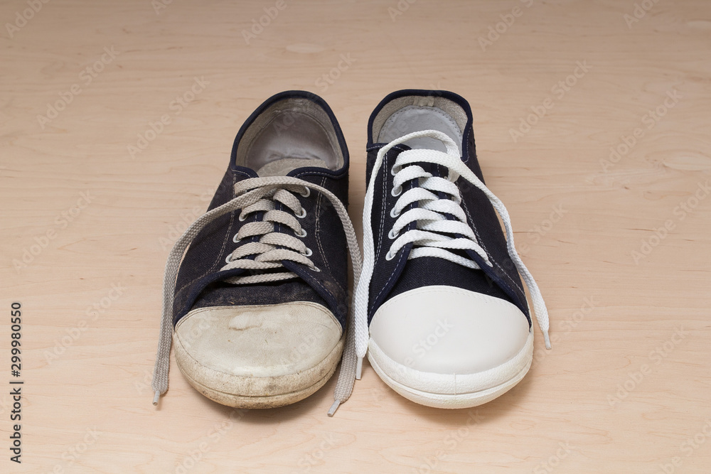 Old dirty shabby and new clean unworn sneakers