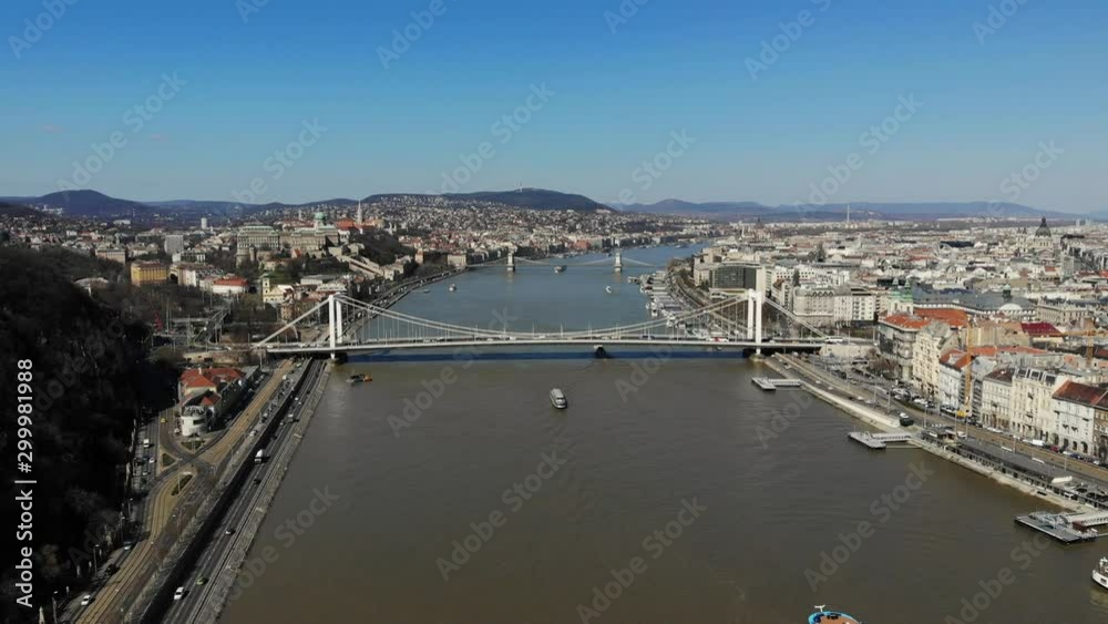 Drone flight above the Danube river in Budapest (Hungary) with the Elisabeth bridge in the center. On the Pest and Buda embankments can be seen the historical buildings of the Hungarian capital. Drone flight above the Danube river in Budapest (Hungary) with the Elisabeth bridge in the center. On the Pest and Buda embankments can be seen the historical buildings of the Hungarian capital.