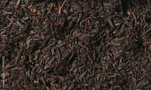 Dry black tea leaves background and texture