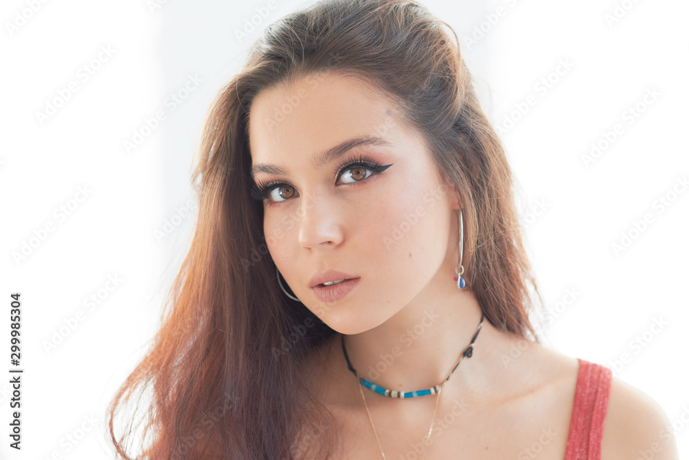 beautiful woman with a serious face isolated on gray background beautiful woman with a serious face isolated on gray background