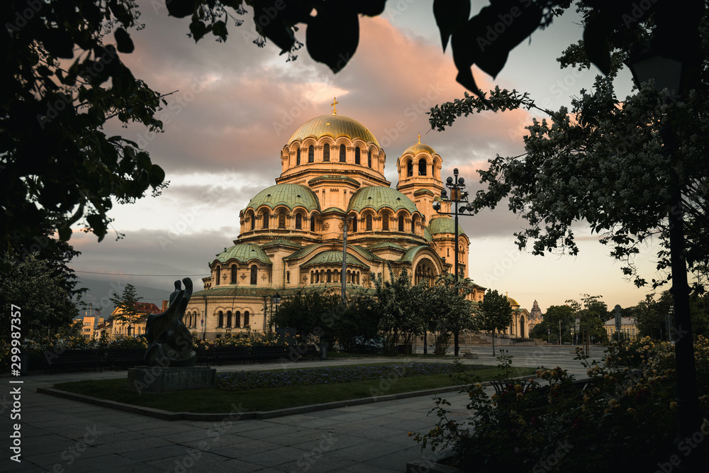 Obraz premium Famous Cathedral Saint Aleksandar Nevski during sunrise with illuminated colourful clouds during summer morning (Sofia, Bulgaria, Europe)