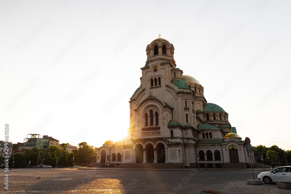 Famous Cathedral Saint Aleksandar Nevski during sunrise with illuminated colourful clouds during summer morning (Sofia, Bulgaria, Europe)