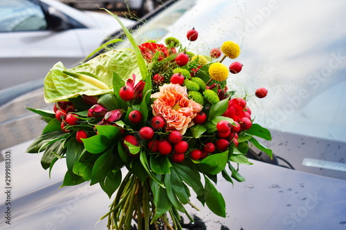 Fototapeta Naklejka Na Ścianę i Meble -  Flower arrangement as a gift. Flowers for mother's day and women's day. Bouquet of flowers by car. Flower delivery. Morning with flowers. Flowers for mother's day and women's day.