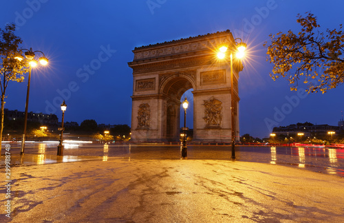 The Triumphal Arch in rainy evening, Paris, France. photo