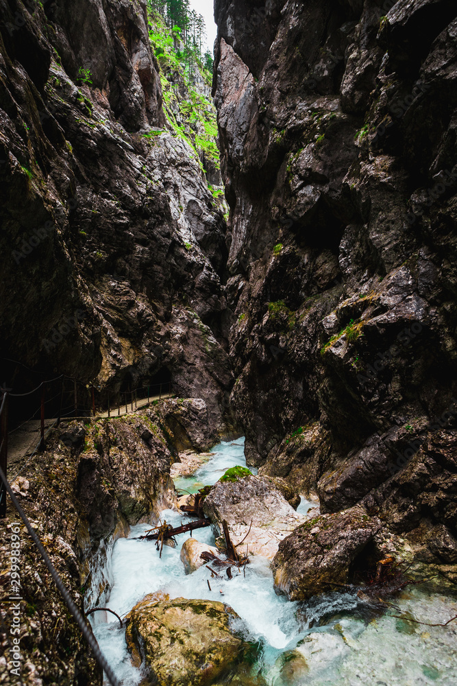Exploring the beauty of Höllentalklamm / Hell Valley Gorge near Grainau during a moody summer day with a clear water stream (Höllental, Germany, Europe) Exploring the beauty of Höllentalklamm / Hell Valley Gorge near Grainau during a moody summer day with a clear water stream (Höllental, Germany, Europe)
