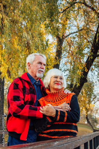 Happy senior couple enjoying each other in the park. Support and care from a loved one  warm emotions.