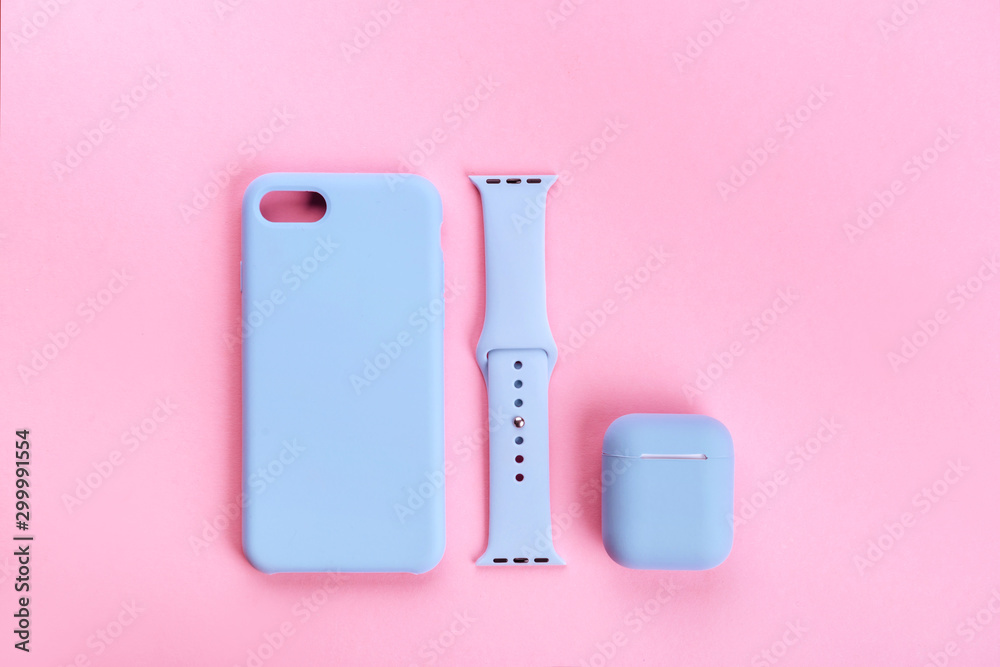Up to date technology.Top view of diverse personal accessory laying on the pink background Up to date technology.Top view of diverse personal accessory laying on the pink background
