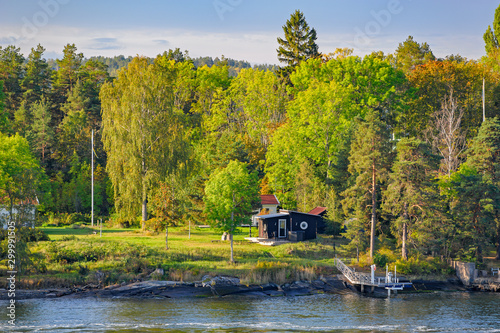 Rocky coast of Stockholm archipelago in Baltic sea with picturesque vacation houses.