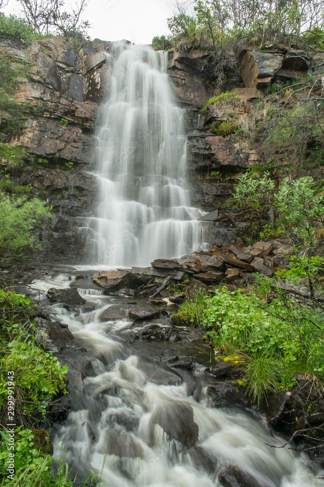 Obraz premium Mountain river and trees landscape natural environment. Hiking in the north of Europe. Natural waterfalls in Norway