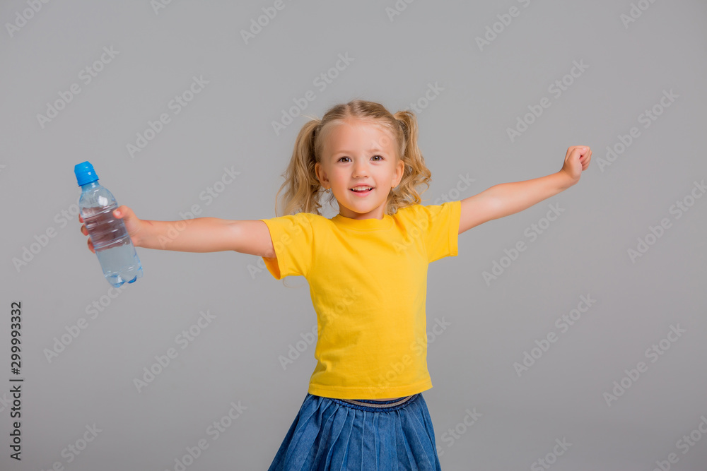 little girl smiling holding bottle of water little girl smiling holding bottle of water