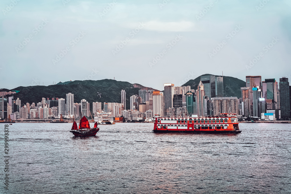 Junk boat at Victoria Harbor of Hong Kong at sundown