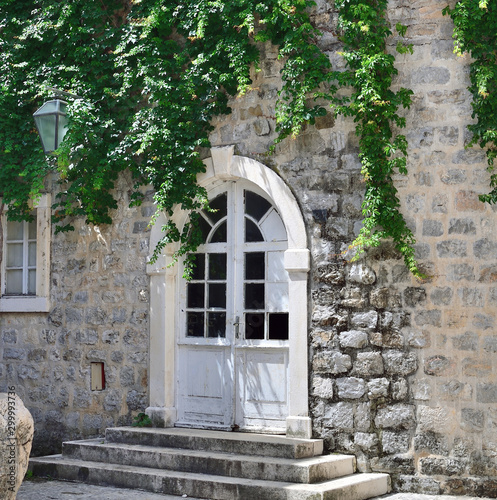 Door in a stone house with twisted plush in Old Town in Budva  Montenegro