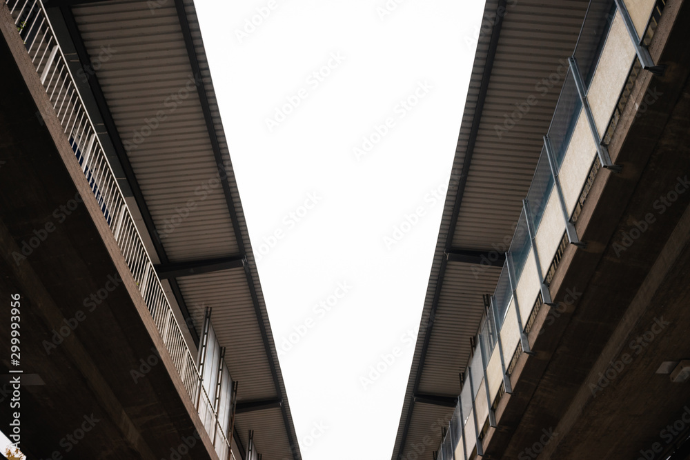 Two bridges joining together with a gray background