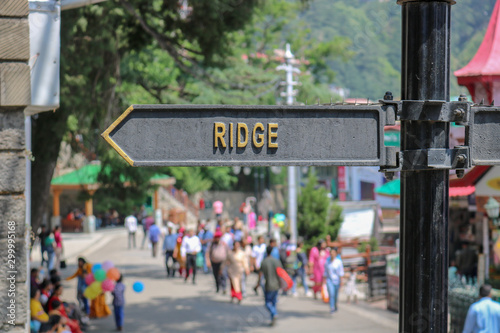 The Ridge road sign / street name. The Ridge road is a large open space, located in the center of Shimla, the capital city of Himachal Pradesh, India. The Ridge is the hub of all cultural activities.
