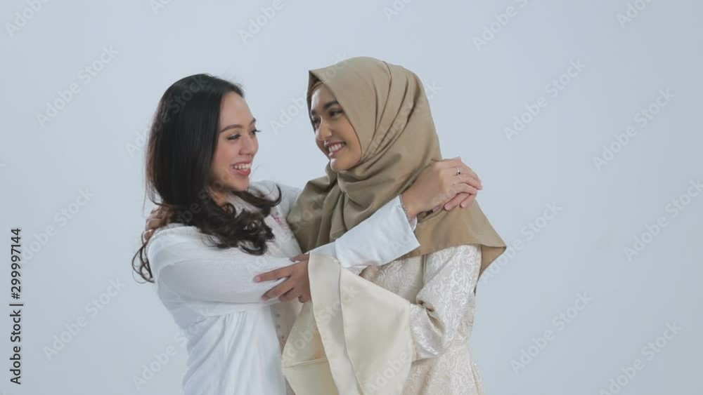 Smiling asian muslim bestfriend in front of camera. eid mubarak concept Smiling asian muslim bestfriend in front of camera. eid mubarak concept