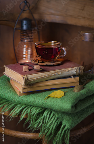 tea, book and plaid on a wooden chairHome interior vintage decor