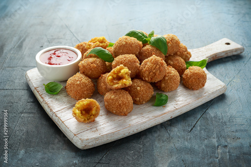 Fried Rice Balls with sweet hot sauce on wooden white board photo